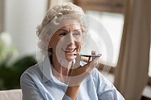 Modern mature woman record voice message on cell