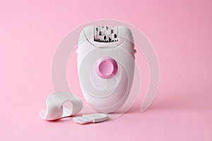 Modern mechanical epilator on a colored background close-up.