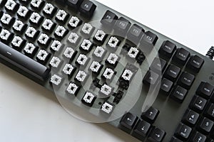 a modern mechanical keyboard switches, black and white keycaps on the desk