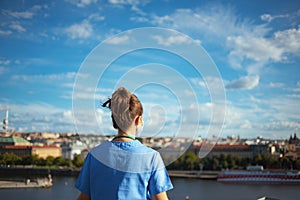 Modern medical doctor woman in scrubs outside against sky