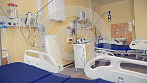 Modern medical equipment and two beds located in a hospital ward