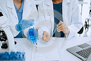 Modern medical research laboratory. female scientist working with micro pipettes analyzing biochemical samples, advanced science