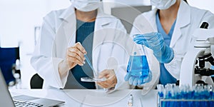 Modern medical research laboratory. female scientist working with micro pipettes analyzing biochemical samples, advanced science