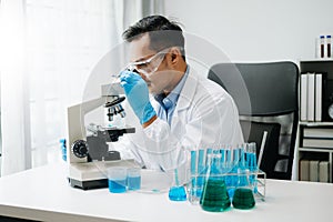 Modern medical research laboratory. male scientist working with micro pipettes analyzing biochemical samples, advanced science