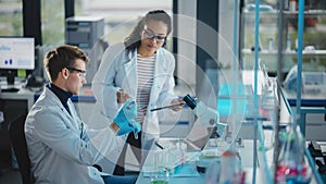 Modern Medical Research Laboratory: Portrait of Two Young Scientists Using Pipette, Digital Tablet
