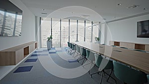 Modern Meeting Room with Chairs, Conference Table and Two TV's