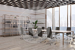 Modern meeting room interior with panoramic windows, city view and furniture. Wooden and concrete walls and floor. Commercial