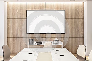 Modern meeting room with mpty frame on wooden wall