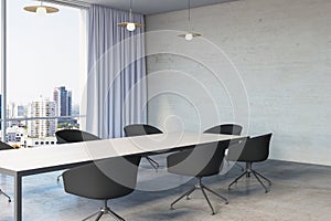 Modern meeting room office interior with table, armchairs, window with city view, curtains and mock up place on wall.