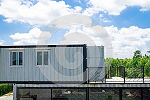 Modern metal building made from shipping house containers and blue sky background