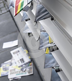 Modern metal mail boxes, overfull of leaflets