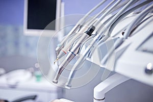 Modern metallic dentist tools and burnishers on a dentist chair in Dentist Clinic