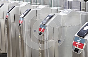 Modern metallic turnstile gate, entrance of railway station. Moscow, Russia