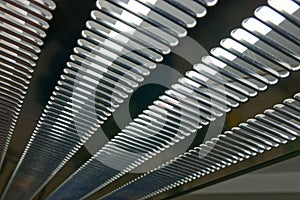 Modern metallic ventilation grille with reflective surface and linear pattern