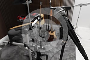 Modern microphone at recording studio, space for text. Music band practice