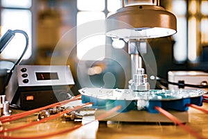 Modern microscope, connectors component and large green microcircuit in workshop laboratory