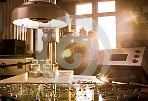 Modern microscope, connectors component and large green microcircuit in workshop laboratory