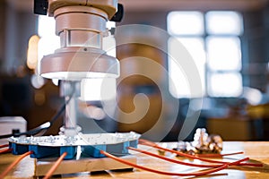 Modern microscope, connectors component and large green microcircuit in workshop laboratory