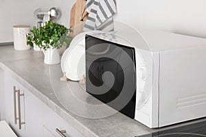 Modern microwave oven on table