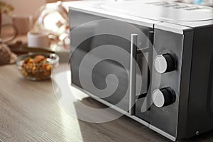 Modern microwave oven on table
