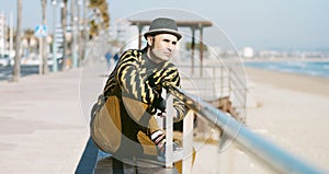 Modern middle-aged man sitting outdoors