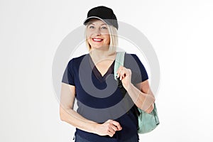 Modern middle aged woman with backpack and cap on a white background, active life concept, copy space background