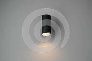 Modern minimal warm light bulb on the bedroom wall