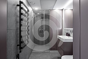 Modern minimalist bathroom interior design with grey stone tiles.