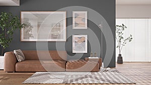 Modern minimalist gray and wooden living room in contemporary apartment with parquet. Brown leather sofa with pillow, capet, floor