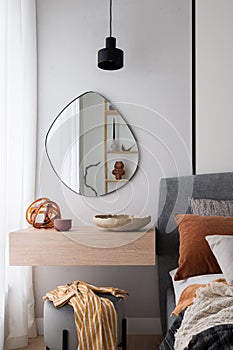 Modern mirror above dressing table in bedroom