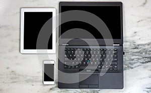 Modern mobile communication devices and computer on marble desktop