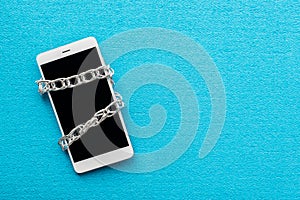 Modern mobile phone with chain locked isolate on blue background