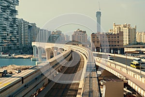 Modern monorail for train in Dubai moving on palm tree shaped island, UAE