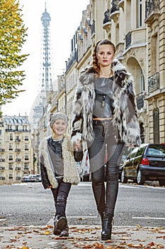 Modern mother and daughter in Paris, France going forward