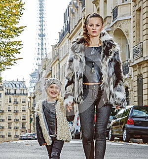 Modern mother and daughter in Paris, France going forward