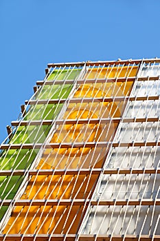 Modern multi colored glass building. Exterior of the local commercial store .