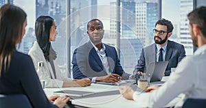 Modern Multi-Ethnic Office Conference Room Meeting: Ambitious Motivated Black Businessman Presenting