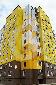 Modern multi-storey house in a new residential complex against the blue sky. The concept of mortgage housing lending and a happy