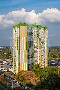 Modern multi-storey residential complex `Fundament` against the backdrop of a cloudy blue sky.