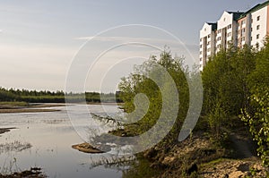 Modern multistage building situated on the bank of the river