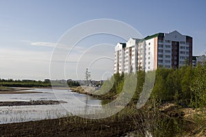 Modern multistage building situated on the bank of the river