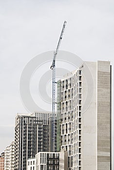 Modern multistory bilding process with a lifting crane. photo