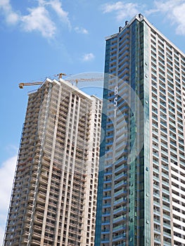 Modern multistory buildings under construction.