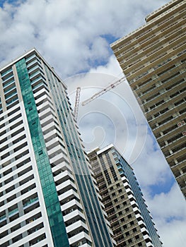 Modern multistory buildings under construction.