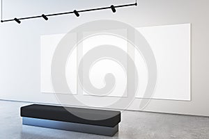 Modern museum or exhibition hall interior with blank white mock up posters on concrete wall and bench.