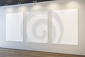 Modern museum or exhibition hall interior with clean illuminated white mock up posters on concrete wall and wooden parquet