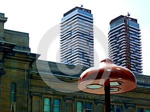 Modern mushroom shaped LED street lamp detail with condo towers in the background