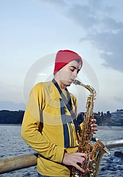 Modern musician posing with his saxophone