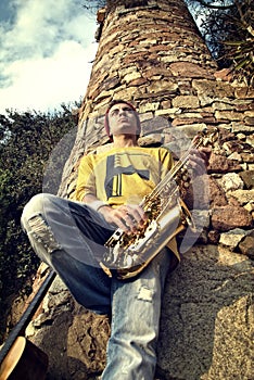 Modern musician posing with his saxophone