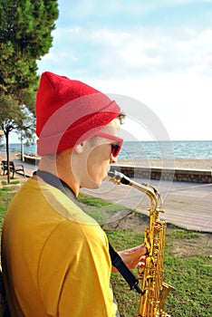 Modern musician posing with his saxophone